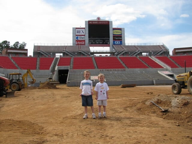 two boys standing in a stadium